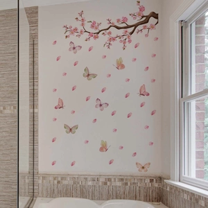 Close-up of pink cherry blossoms and colorful butterfly wall stickers in a bathroom