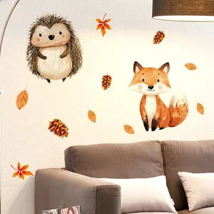 Detail of cartoon fox and hedgehog wall stickers with autumn leaves in a cozy living room