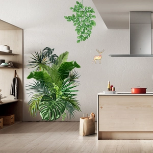 Nordic wall decals featuring tropical monstera leaves and colorful deer in a modern kitchen