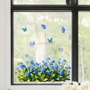 Détail de stickers électrostatiques fleurs bleues et papillons sur verre transparent