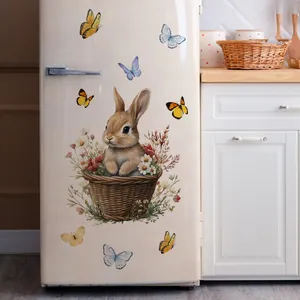 Detail of cute rabbit in basket and butterflies wall stickers on a vintage white fridge