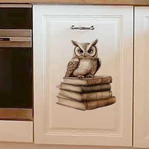 Detail of owl and vintage books sticker on white textured kitchen cabinet door