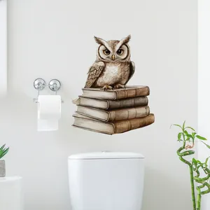 Detail of owl and vintage books wall sticker on white wall in a modern bathroom