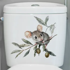 Detail view of a watercolor mouse on an olive branch sticker applied to a toilet tank