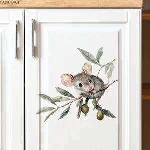 Detail of watercolor mouse on olive branch sticker applied to a white kitchen cabinet