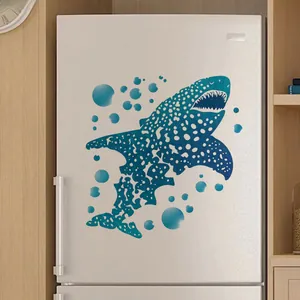 Detail of blue shark wall sticker with bubbles applied on a white kitchen appliance