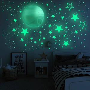 Luminous moon and star wall stickers glowing in a dark modern children's bedroom