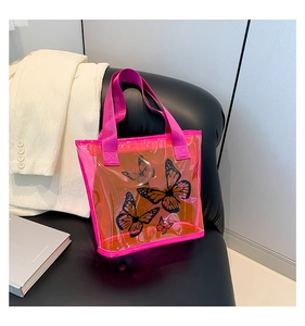 Detail view of pink transparent PVC tote bag featuring elegant black butterfly prints