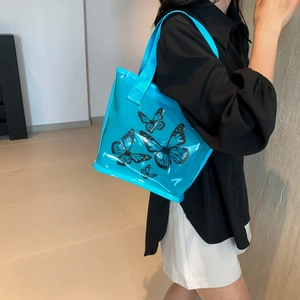 Blue transparent PVC tote bag with butterfly prints for summer casual fashion use
