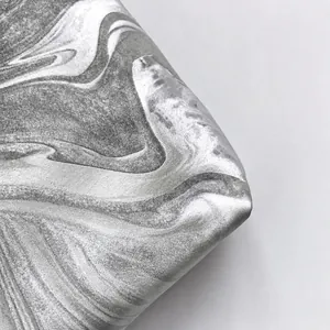 Macro shot of silver-grey marble textured fabric with metallic liquid gloss finish