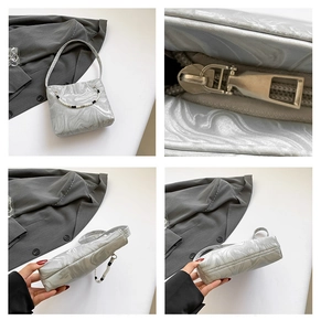 Detail of silver marble shoulder bag with beaded handle and smooth metal zipper closure
