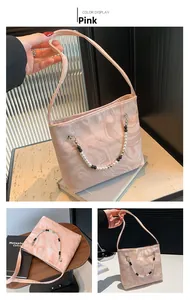 Detail of pink marble pattern shoulder bag with a stylish beaded decorative chain