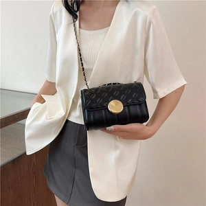 Elegant black quilted crossbody bag with gold chain strap and luxury circular metal lock