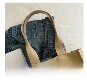 Detailed close-up of khaki canvas tote bag handle with reinforced woven texture