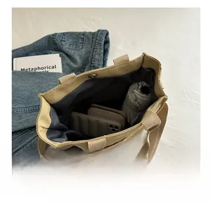 Detailed internal view showing large capacity storage in beige canvas tote bag