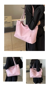 Detail view of pink tote bag showing soft nylon material and adjustable shoulder straps