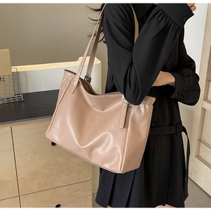 Close-up of beige tote bag made of high-quality faux leather with fine texture