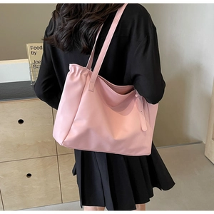 Pink large capacity tote bag shown on model for daily commuting and student use