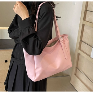 Pink large capacity tote bag shown on model for daily commuting and office style