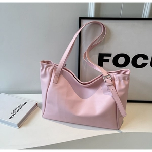 Detailed view of pink tote bag with high-quality synthetic leather and silver metal buckles