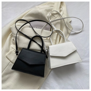 Detail of minimalist mini handbag in black and white with smooth matte leather texture
