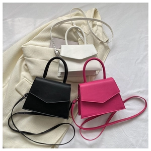 Trio of mini trapezoid handbags in white, black and rose pink on textured fabric