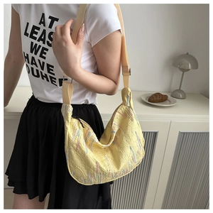 Detail of yellow Oxford cloth tote bag showing textured fabric and colorful stripes