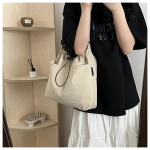 Japanese style nylon bucket bag detail showing drawstring closure and front pockets
