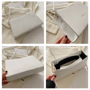 Dettaglio della borsa bianca in pelle PU con scritta FASHION oro e vani interni