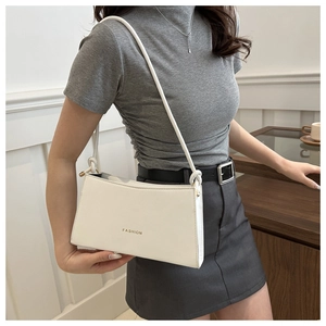 Minimalist white leather underarm bag with gold FASHION lettering and knotted strap detail
