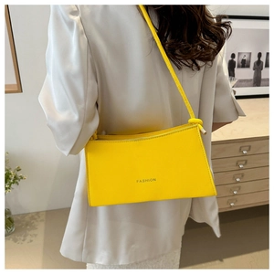 Detailed back view of model wearing a bright yellow rectangle PU leather shoulder bag
