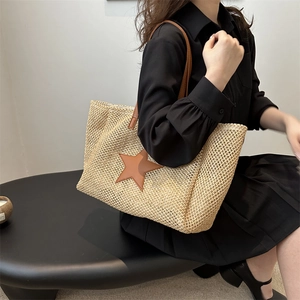 Summer straw tote bag with brown star patch and leather handles for casual beach style