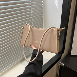 Chic beige baguette underarm bag with gold FASHION lettering and slim shoulder strap