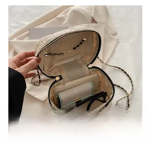 Internal view of beige woven straw chain bag showing space for phone and wallet