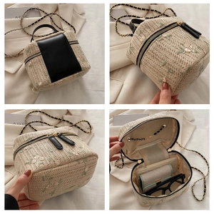 Detail of floral embroidery and interior capacity of the beige drawstring bucket bag