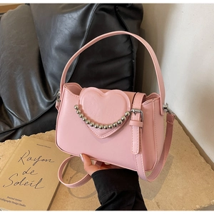 Detail of pink PU leather handbag featuring a heart motif and silver bead metal chain strap