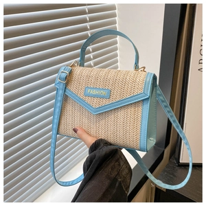 Detail of a chic beige woven handbag with sky blue leather trim and fashion lettering