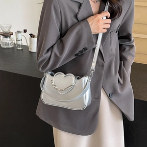 Silver heart chain shoulder bag with metallic bead trim and elegant saddle shape design
