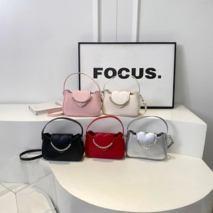 Minimalist heart flap mini handbag with silver bead chain in five colors on a display