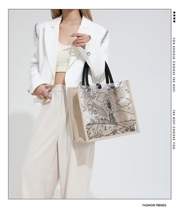Detail of transparent PVC tote bag with straw base and pastoral windmill illustration