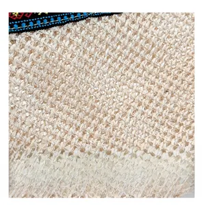 Detail of hand-woven straw texture and colorful ethnic embroidery on a summer clutch bag