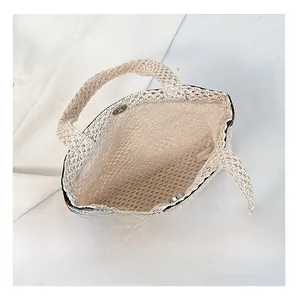 Internal view of the woven envelope bag featuring magnetic closure and striped edge detail