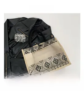 Close-up of semi-transparent tote bag with geometric patterns and beige fabric straps