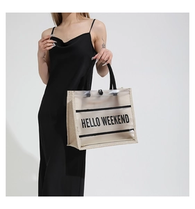 Detail of transparent PVC and jute tote bag with HELLO WEEKEND text print