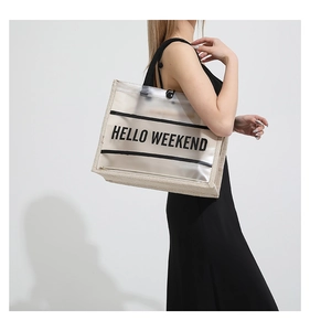 Detail of PVC tote with HELLO WEEKEND print and linen stitching on model