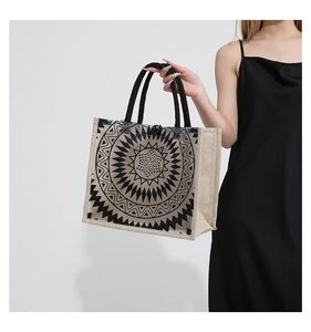 Detail of canvas tote bag showing black mandala print and durable rope handles