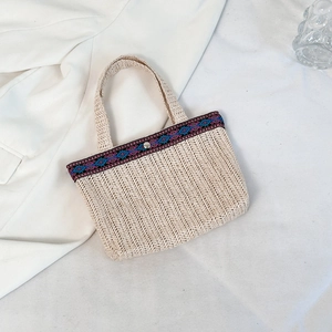 Bohemian straw clutch bag with colorful ethnic geometric ribbon and metal snap button