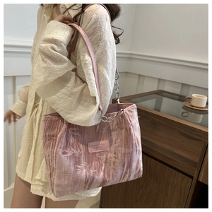 Detail of pink velvet tote bag with bamboo texture and silver chain strap for women