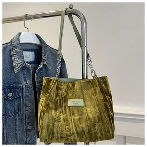 Green velvet tote bag with bamboo leaf pattern and metal chain strap detail