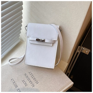 Close-up of white mini phone bag with cross-grain texture and silver twist lock detail
